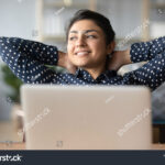 stock-photo-head-shot-young-indian-woman-crossed-hands-behind-head-enjoying-break-time-at-home-peaceful-1721092138